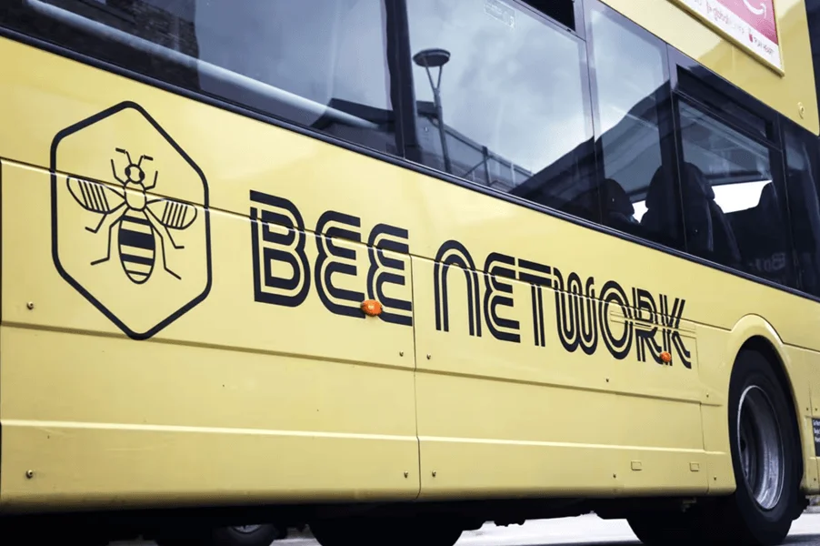 An image of a bee and other black vehicle graphics that read, "Bee Network" on a yellow bus.
